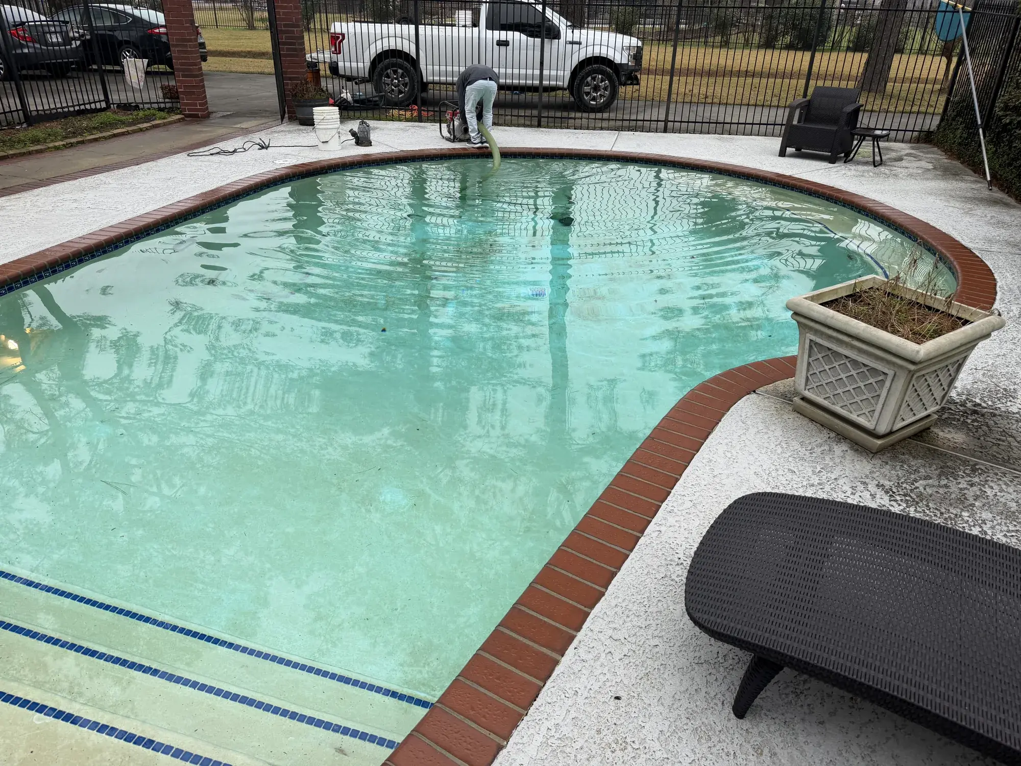 Backyard in-ground pool with sun shelf and modern decking by Sam Houston Pools and Outdoors