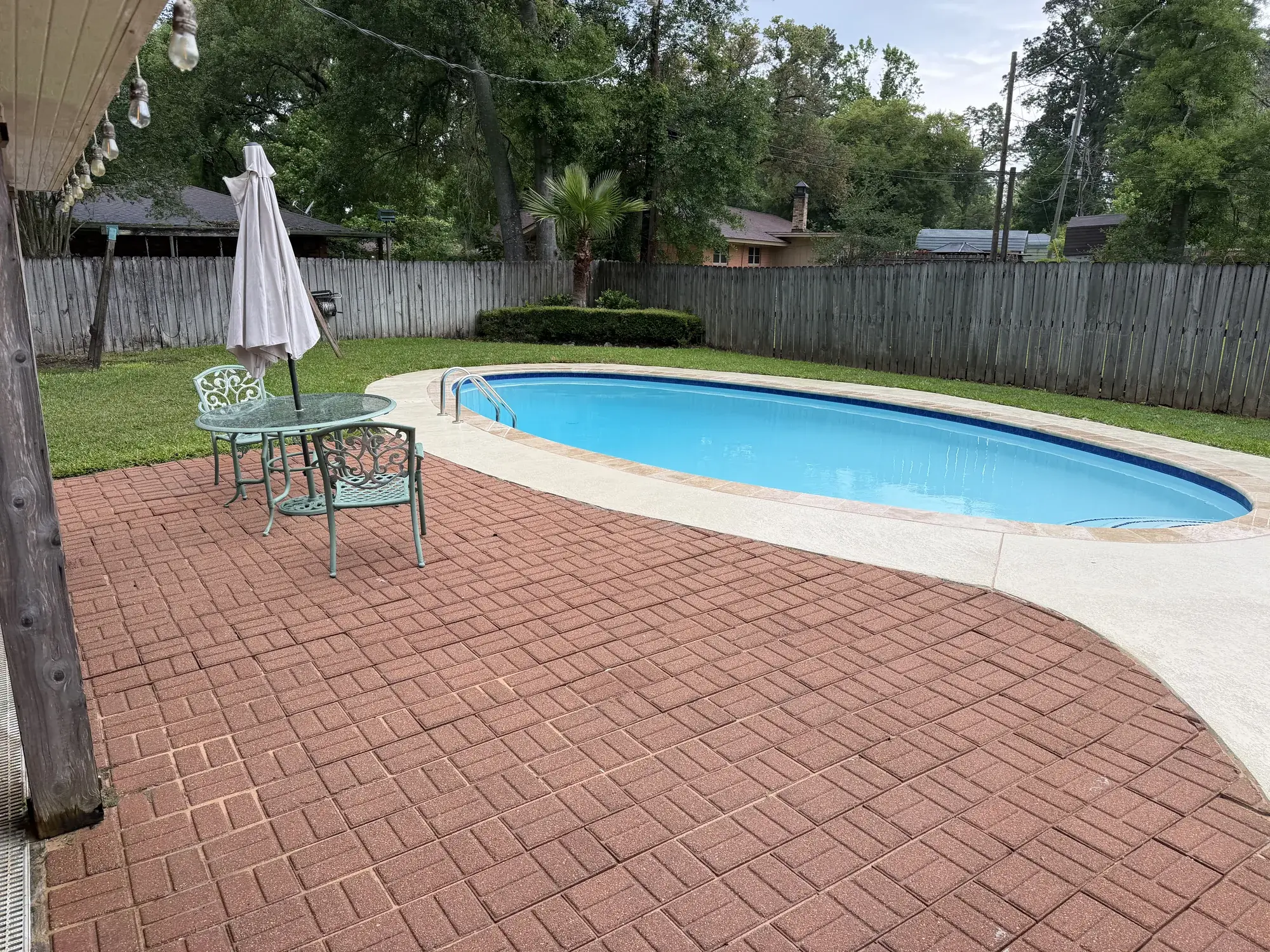 Modern pool design with sharp geometric lines and contemporary deck finish, built by Sam Houston Pools in Houston County, TX