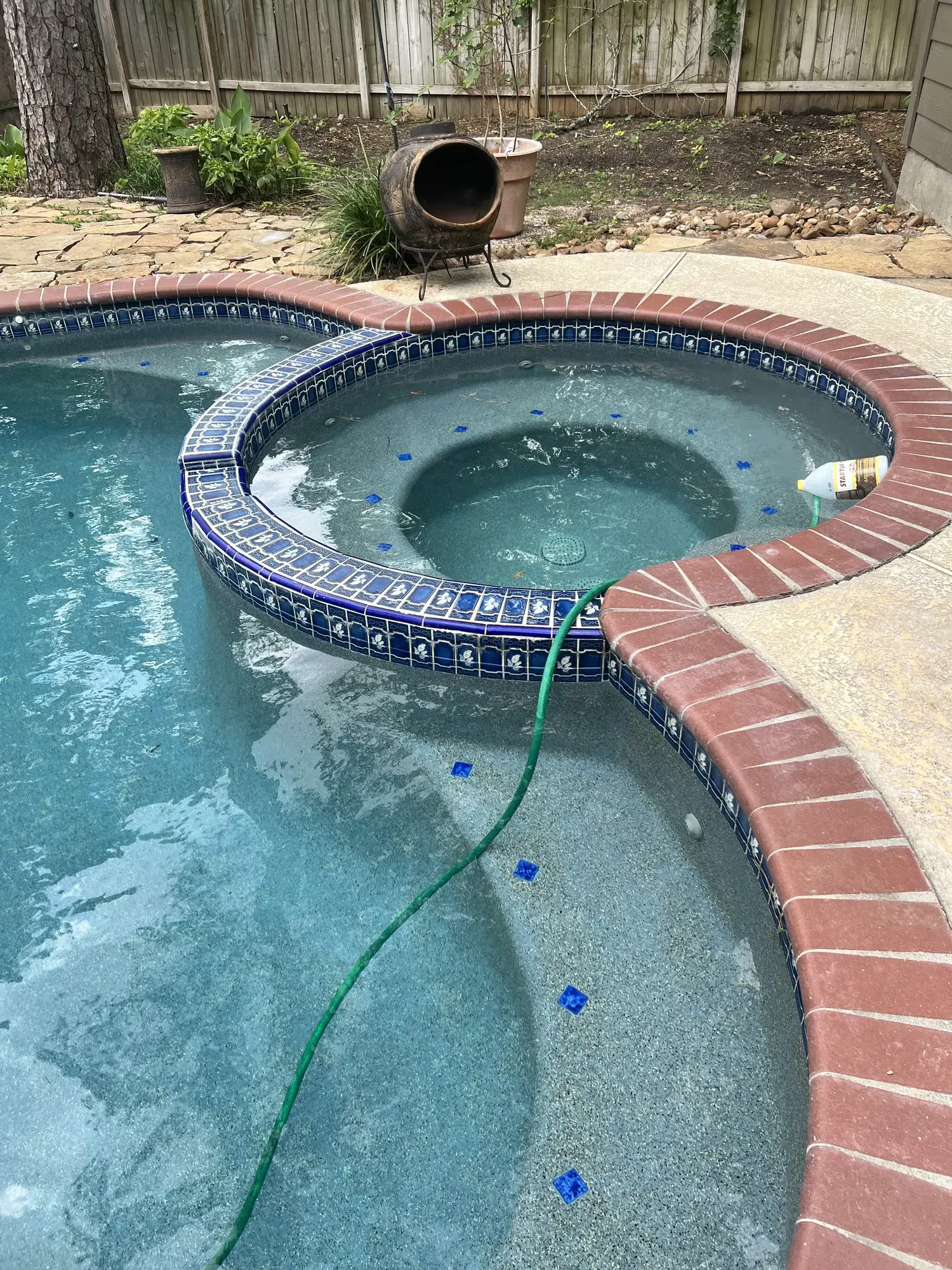 Recently completed Sam Houston Pools installation showing finished pool, decking, and surround