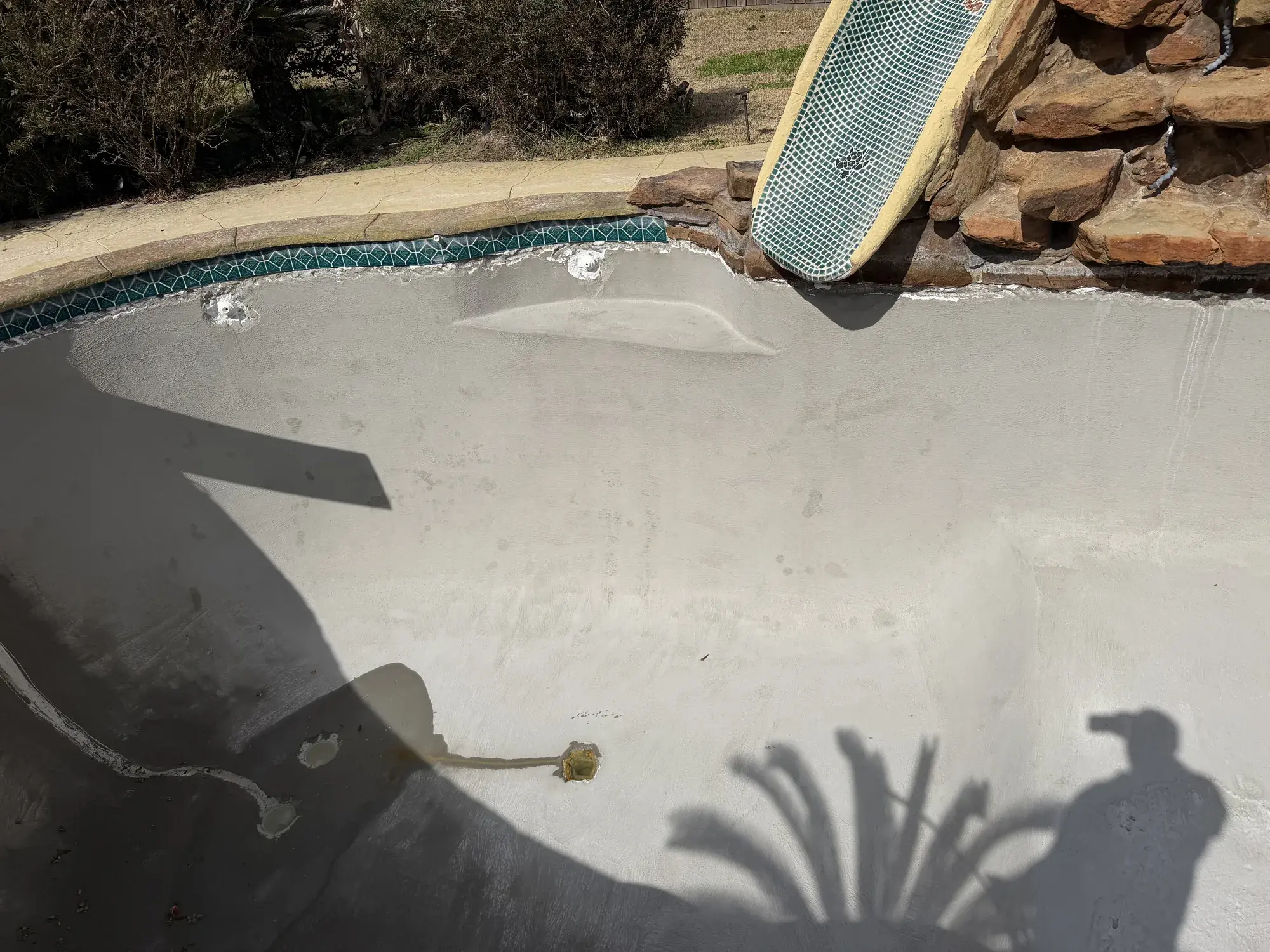 Sam Houston Pools and Outdoors portfolio project — custom in-ground pool with attached spa in an East Texas backyard