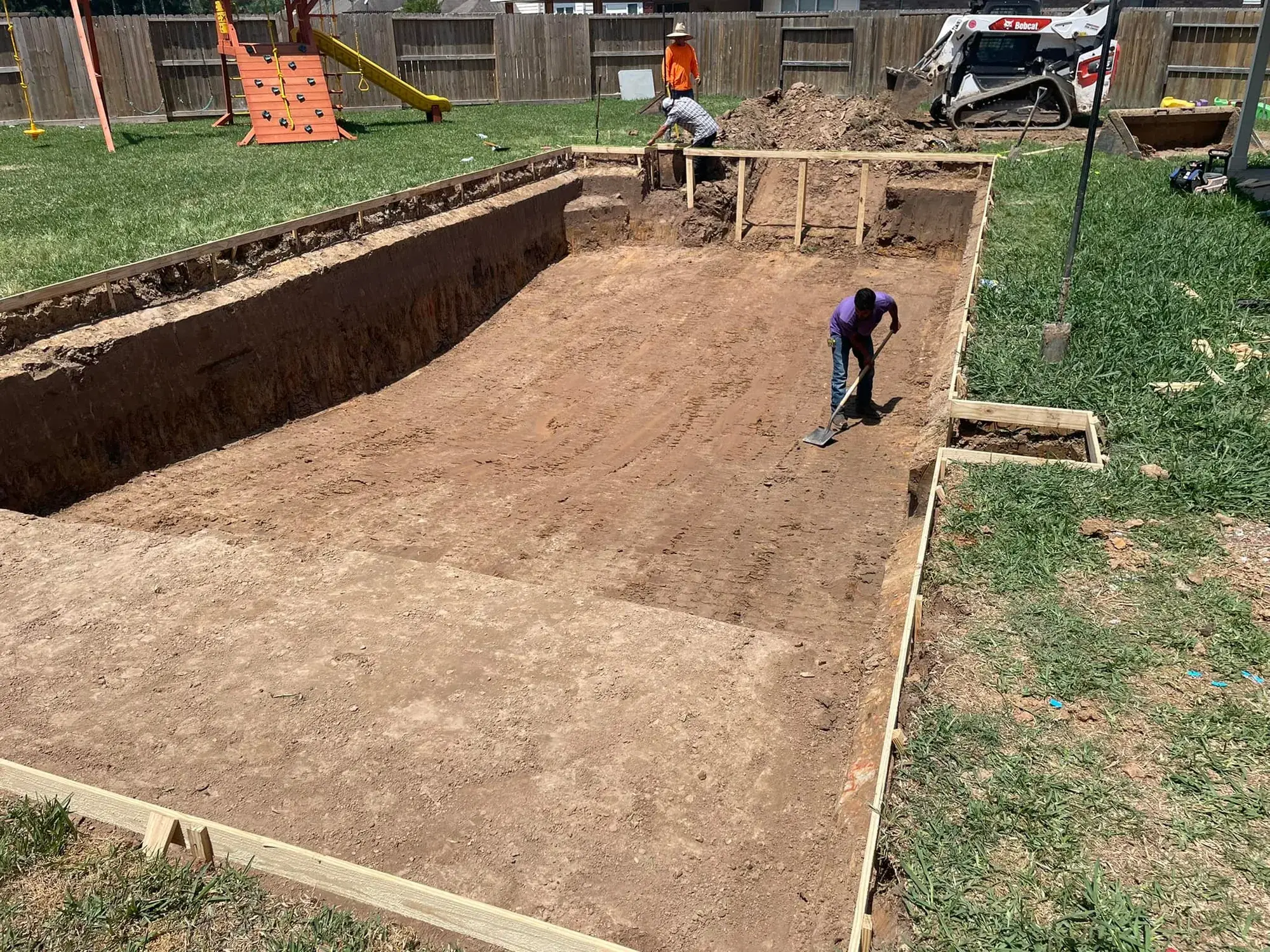 Swimming pool excavation in progress at the start of a new in-ground pool construction project in the Houston area